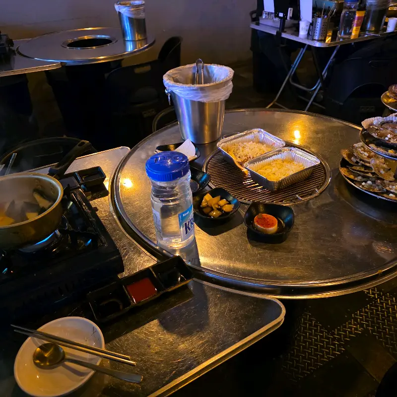 불판 위에 올려진 가리비와 콘치즈