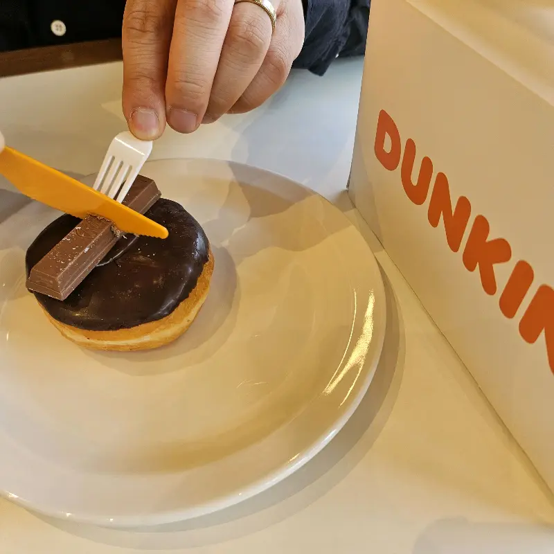 포크와 나이프로 도넛을 먹는 모습