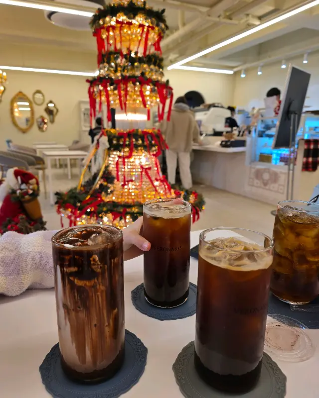 음료와 함께 보이는 카페 내부의 크리스마스 장식