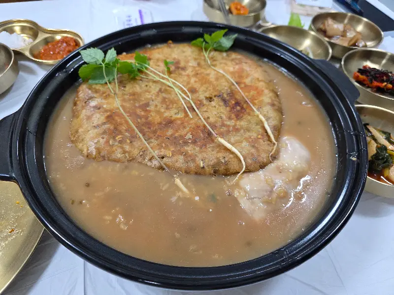 뽀얀 국물 위에 바삭한 누룽지가 덮여 있는 누룽지백숙
