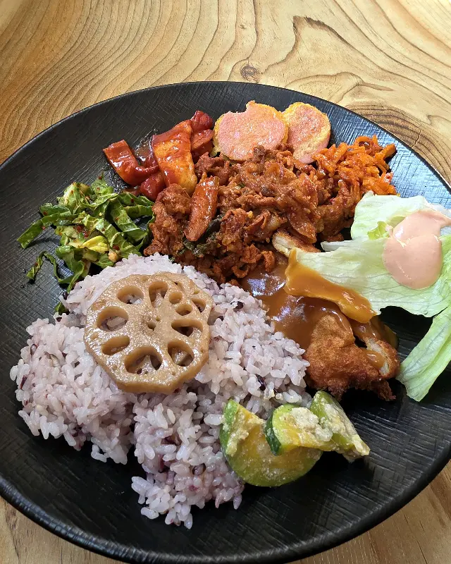 다양한 반찬과 밥, 돈까스가 담긴 접시