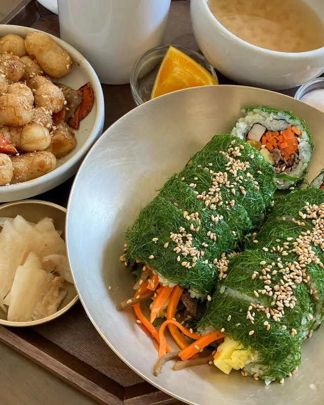 감태김밥, 궁중떡볶이, 따뜻한 차가 함께 놓인 쟁반