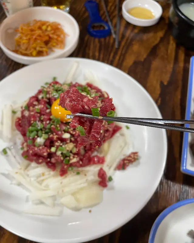 뭉티기와 곁들여 먹는 백김치의 모습