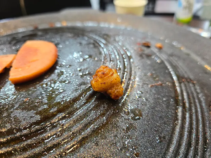 솥뚜껑에 구워진 오겹살 조각