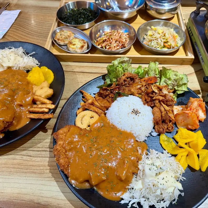 돈까스와 돼지찌개가 함께 놓인 푸짐한 한 상 차림