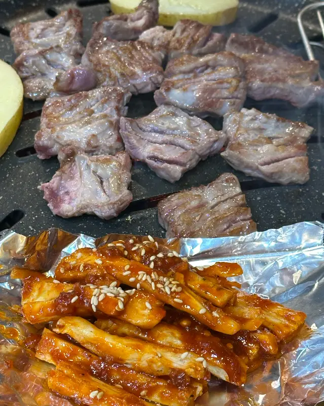 불판 위에서 구워지고 있는 더덕구이