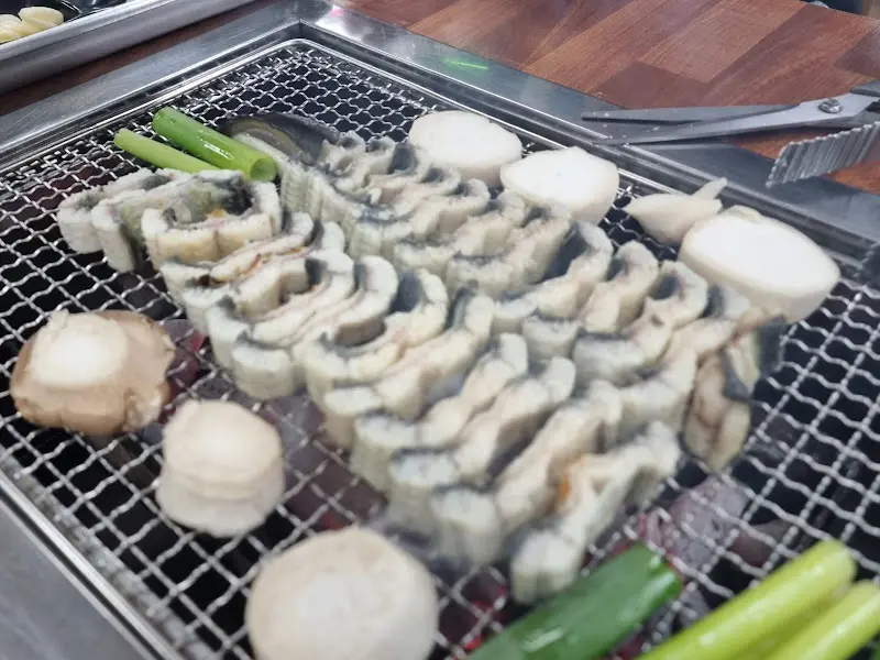 불판 위에 구워진 버섯과 양파