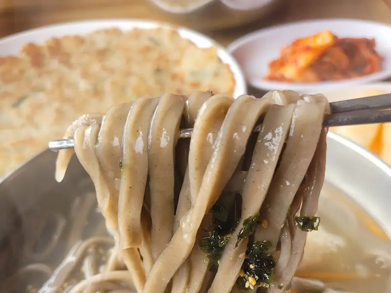 젓가락으로 집어올린 옹심이칼국수 면발