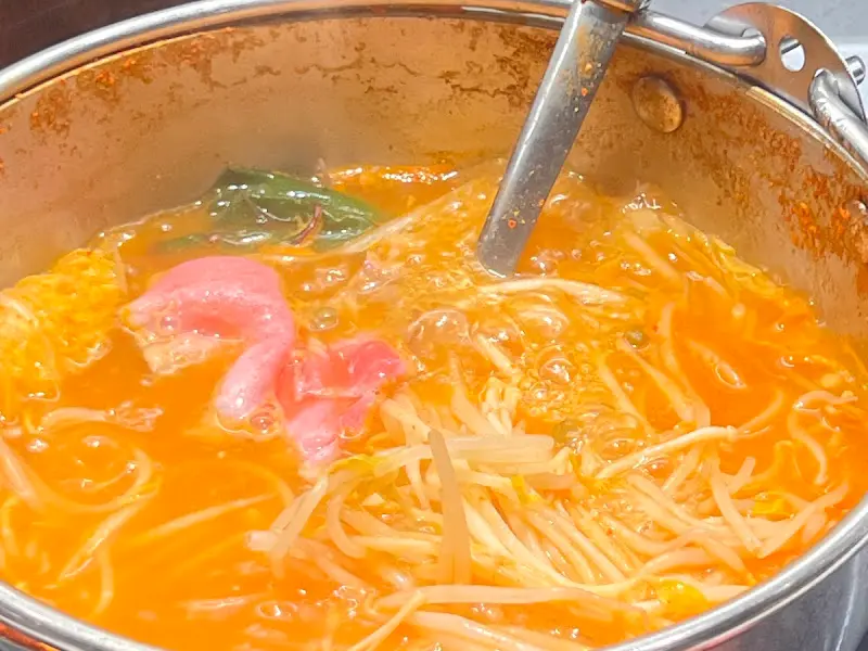 매콤한 육수에 샤브샤브 재료가 가득 담긴 모습