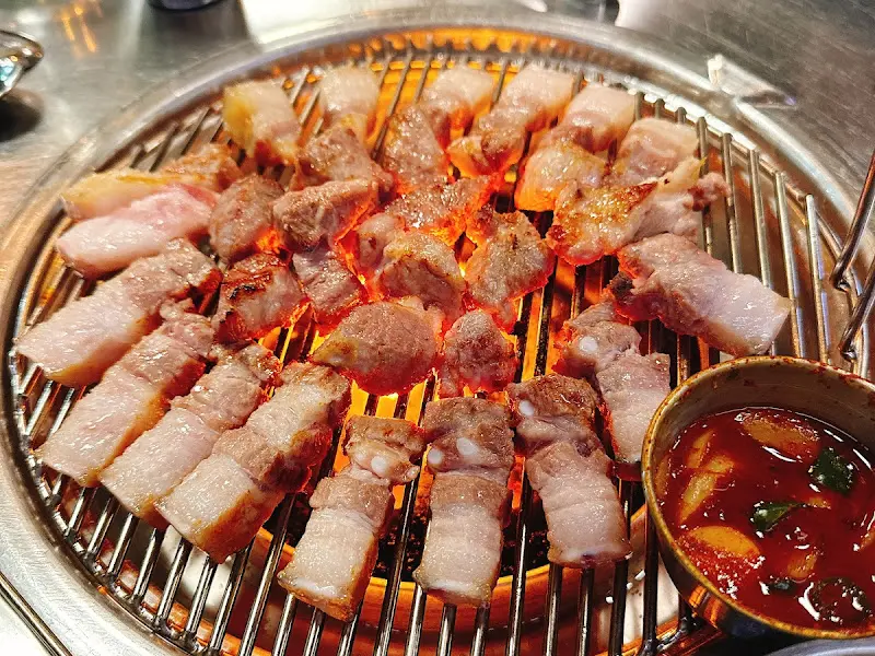 연탄불 위에서 맛있게 구워지고 있는 흑돼지 근고기