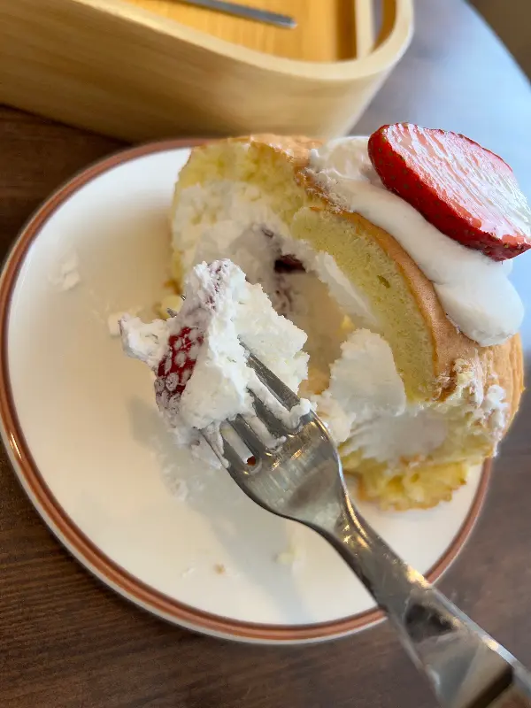 딸기 롤케이크를 포크로 떠먹는 모습