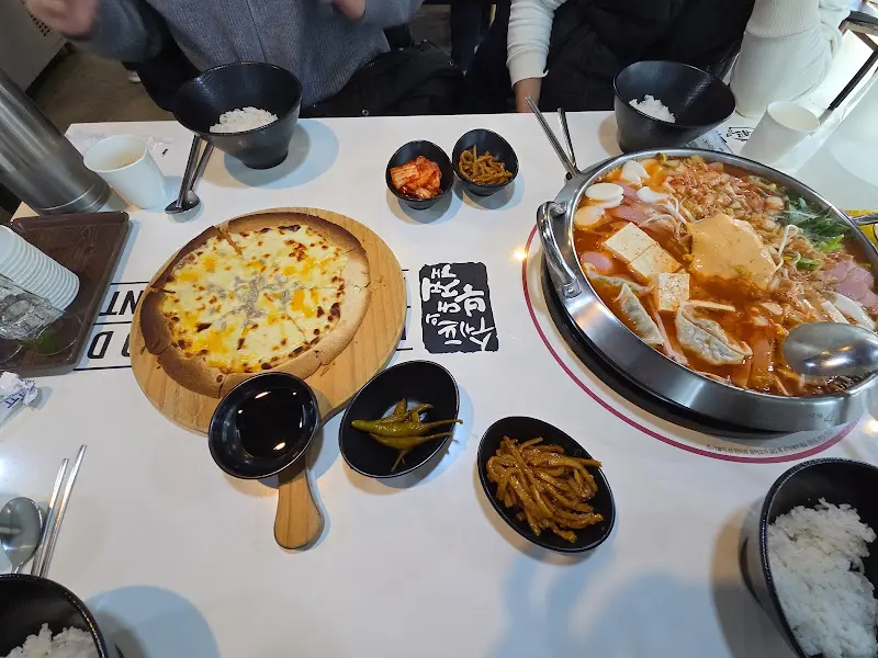 부대찌개와 돈까스, 피자가 함께 차려진 푸짐한 상차림