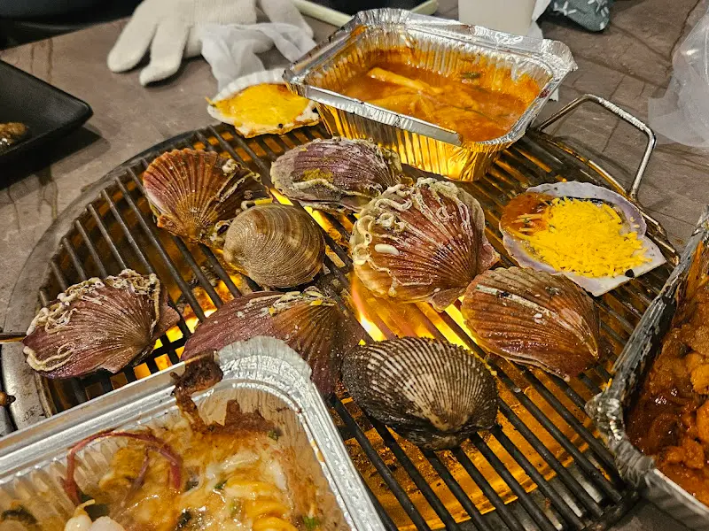 불판 위에서 맛있게 익어가는 조개들