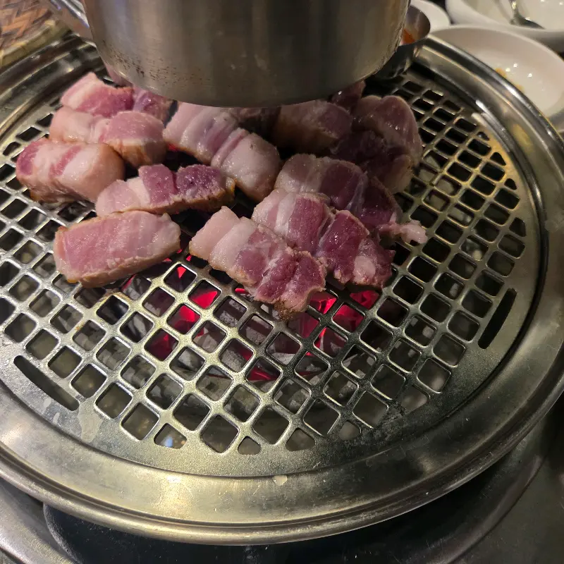 숯불 위에서 구워지는 흑돼지 삼겹살