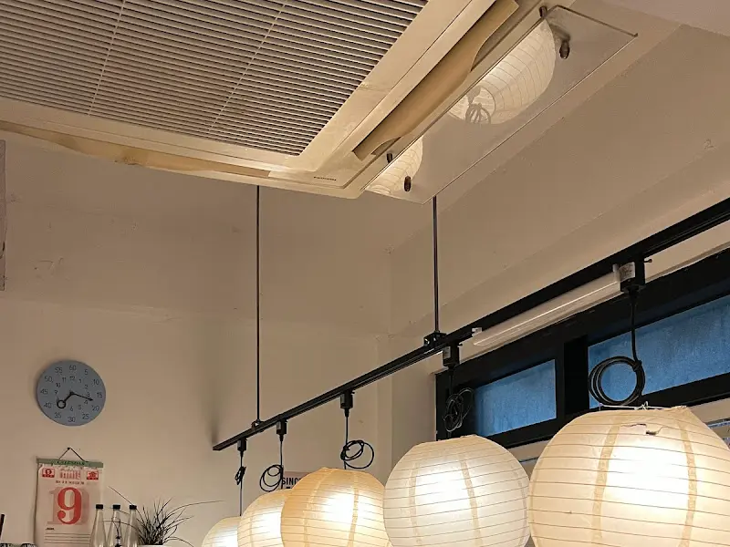 이자카야 내부 모습. 천장에 달린 조명과 벽에 붙은 메모들이 아늑한 분위기를 연출한다.