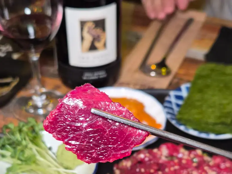 젓가락으로 뭉티기를 집어 올리는 모습