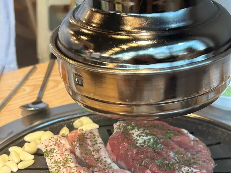 불판 위에서 익어가는 삼겹살과 마늘