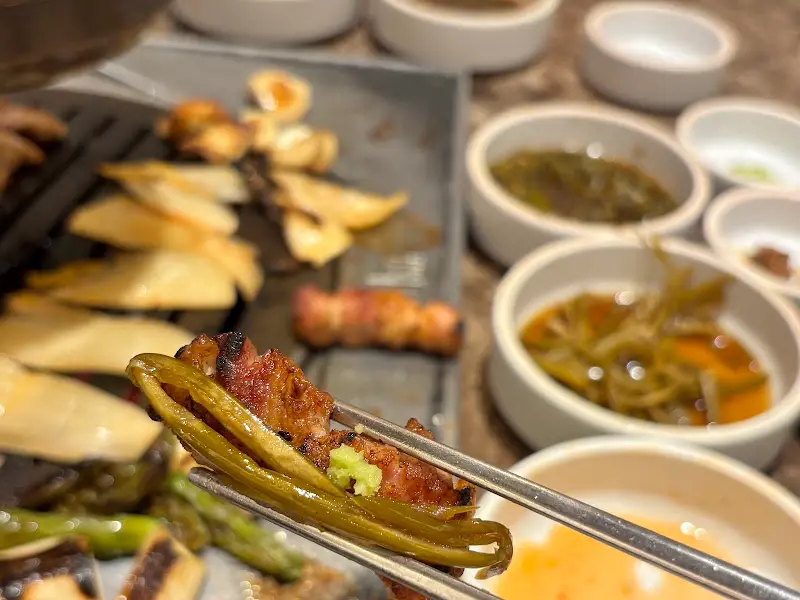 고기와 구운 채소를 함께 곁들여 먹는 모습
