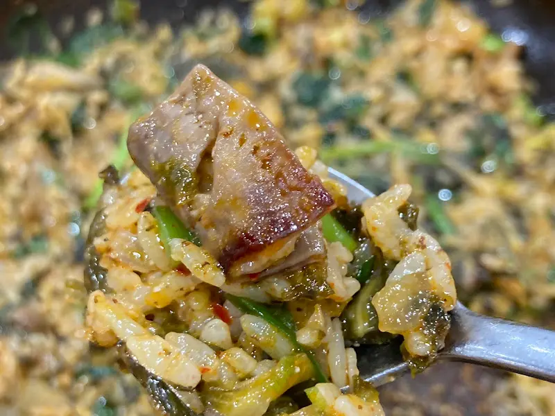 숟가락 위에 올려진 볶음밥과 내장