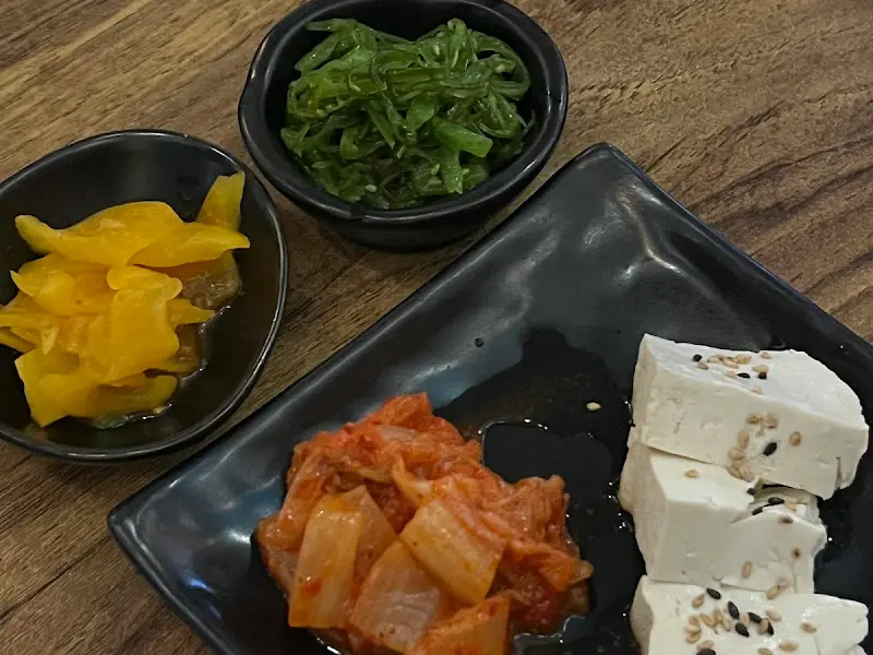 기본 안주로 제공되는 크림치즈 두부, 김치, 단무지, 미역