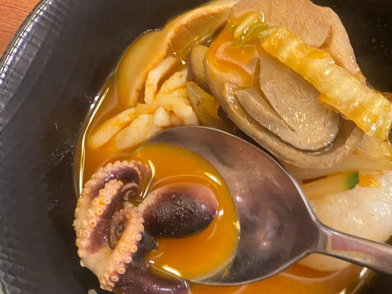 숟가락으로 짬뽕 국물을 뜨는 모습