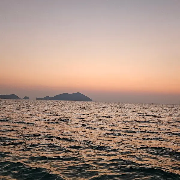 잔잔한 파도가 치는 바다의 석양