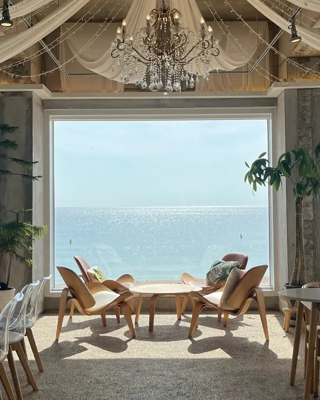 카페 내부 좌석과 통창으로 보이는 바다