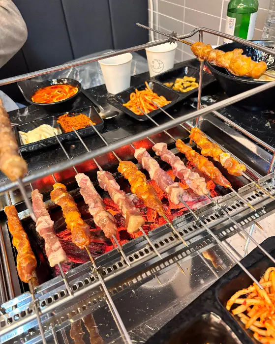 다양한 꼬치구이가 숯불 위에서 익어가는 모습