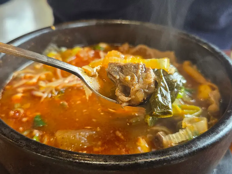 숟가락으로 떠올린 해장국의 푸짐한 건더기