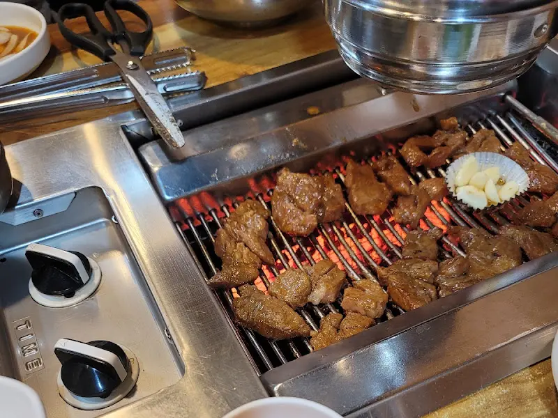 불판 위에서 익어가는 돼지갈비와 마늘