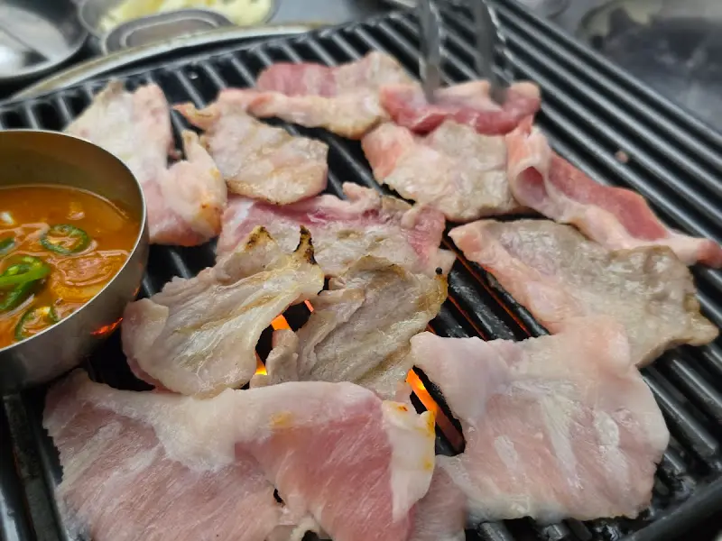 연탄불에 구워지는 다양한 부위의 고기