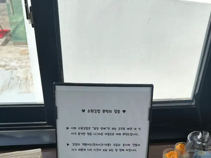 가게 내부에 놓인 소원김밥에 대한 글