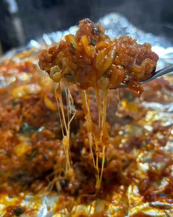 치즈가 듬뿍 녹아내린 볶음밥 한 숟가락. 김치와 밥알, 그리고 녹아내린 치즈의 조화가 침샘을 자극한다.