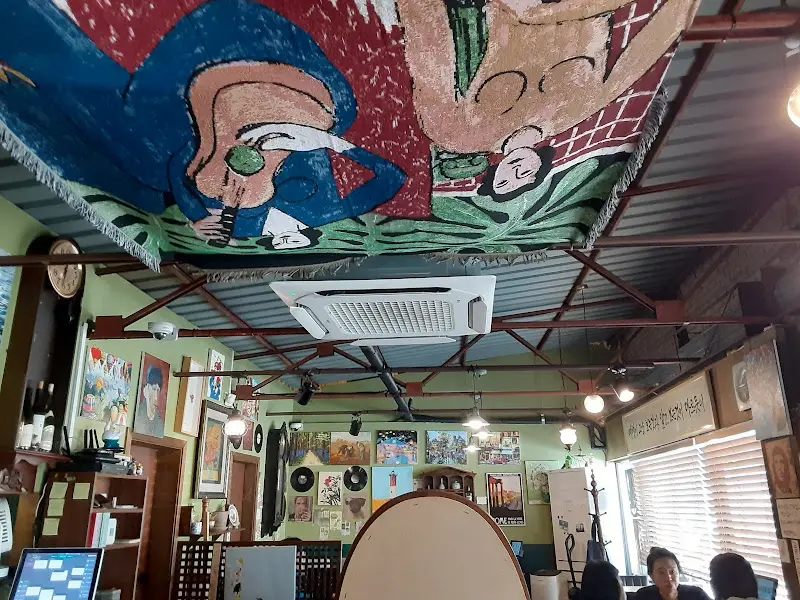 천장에 걸려있는 그림이 그려진 천 사진. 독특한 분위기를 자아낸다.