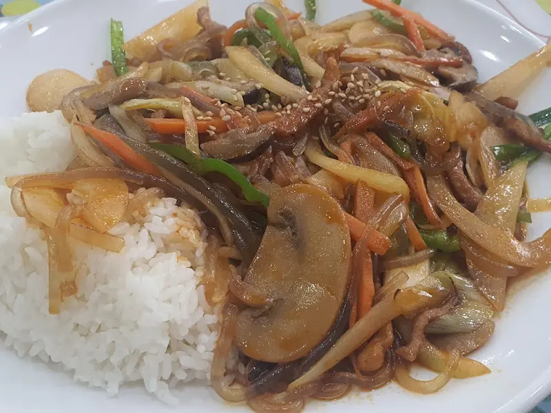 고슬고슬한 밥알 위에 얹어진 유산슬 소스