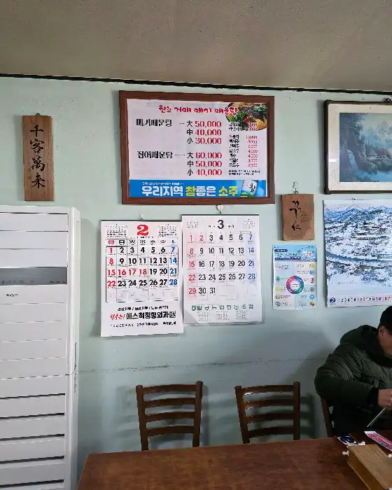 가게 내부 벽면에 걸린 메뉴판과 달력