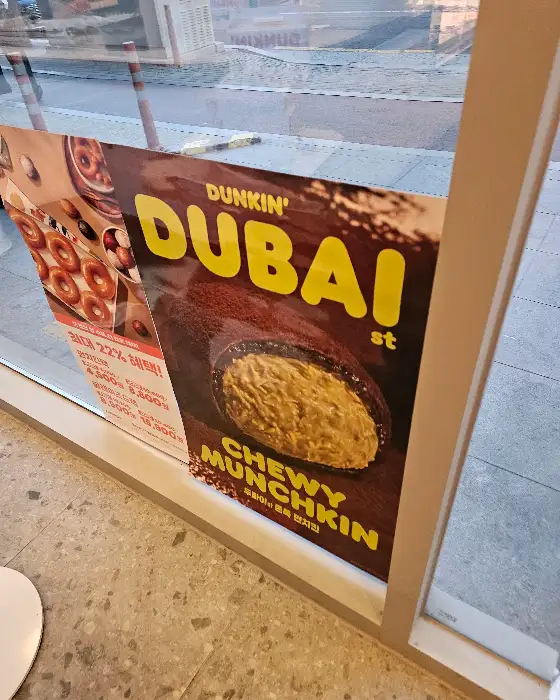 창가에 붙어있는 'DUBAI st CHEWY MUNCHKIN' 홍보물