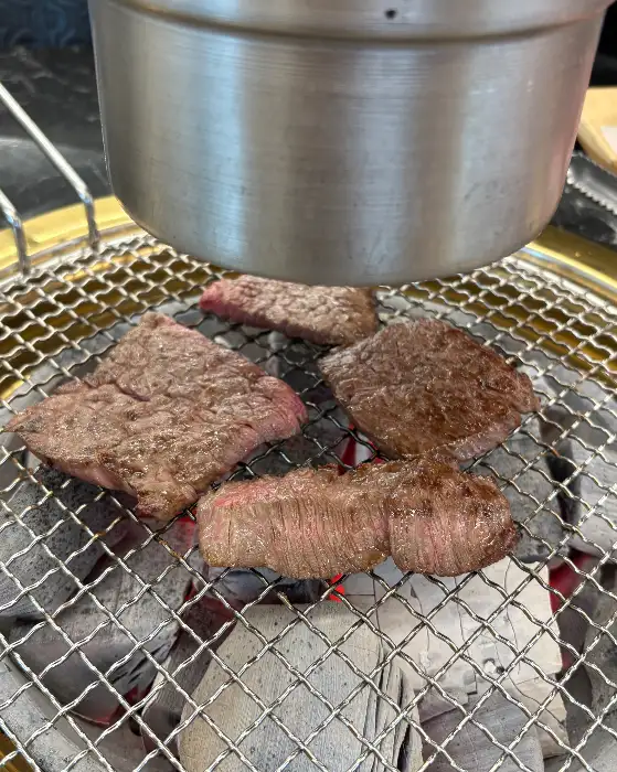 숯불 위에서 구워지고 있는 소고기 스테이크