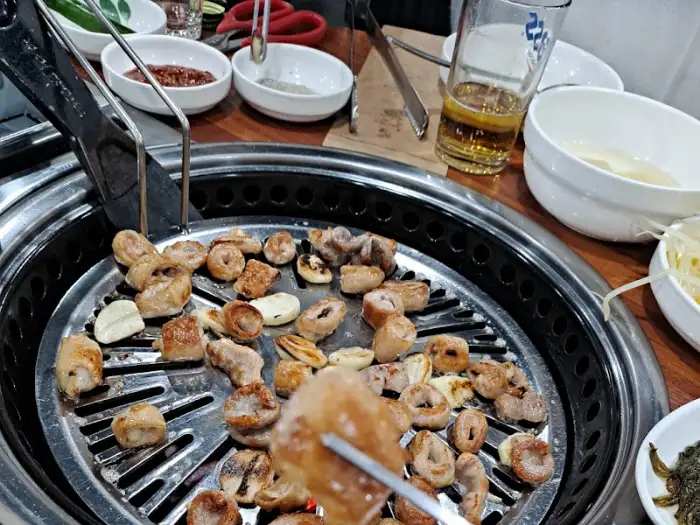 집게로 집어 올린 곱창 조각