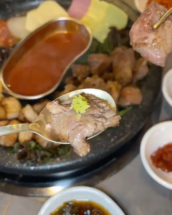 숟가락에 담긴 고기 조각에 와사비가 올려져 있음