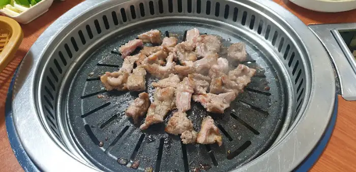 숯불 위에서 노릇하게 익어가고 있는 고기 조각들