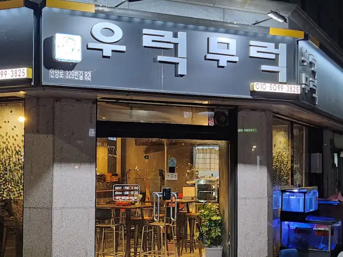 식당의 간판이 밤에 조명을 받아 빛나고 있습니다.