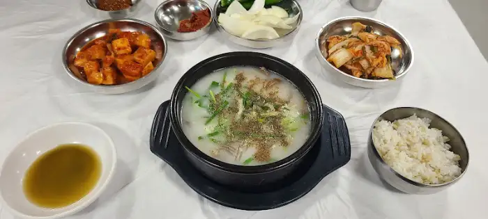 테이블 위에 놓인 소머리국밥과 밥, 김치