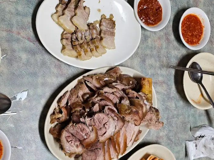 다른 접시에 담긴 썰어놓은 보쌈 조각들, 족발과 나란히 놓여있음