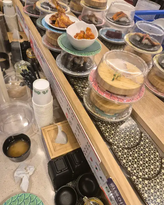 회전 초밥 레일과 다양한 초밥 접시들