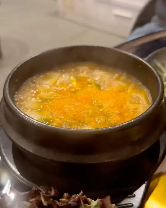 따뜻하게 끓고 있는 된장찌개의 모습. 두부와 채소가 듬뿍 들어있어 푸짐해 보입니다.
