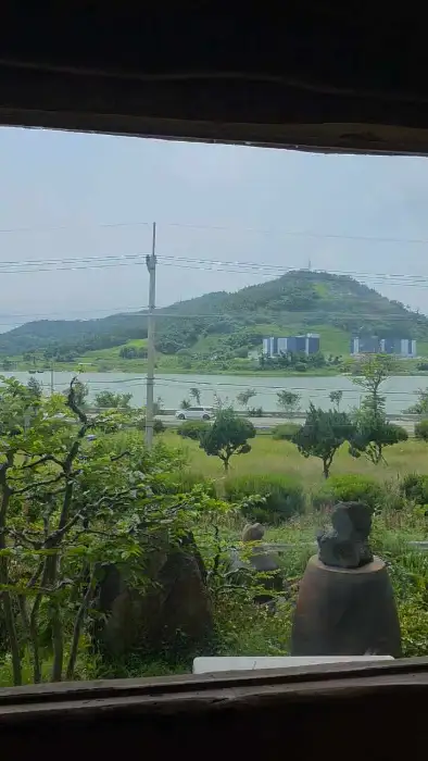 창밖으로 보이는 산과 강, 그리고 건물들이 있는 풍경
