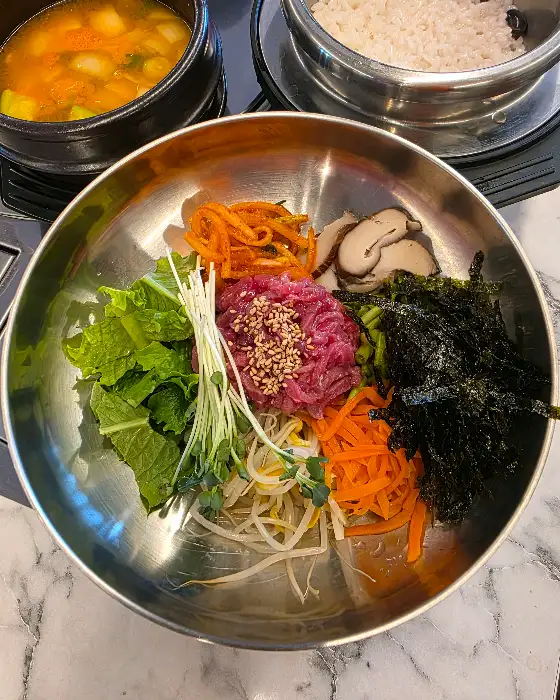 신선한 채소와 육회가 푸짐하게 올라간 육회비빔밥