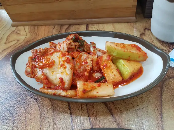 김치와 깍두기가 담긴 접시. 먹음직스러운 붉은 빛깔을 띠고 있다.