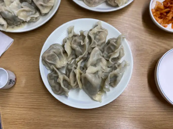 참치만두와 다른 종류의 만두들이 함께 담긴 접시
